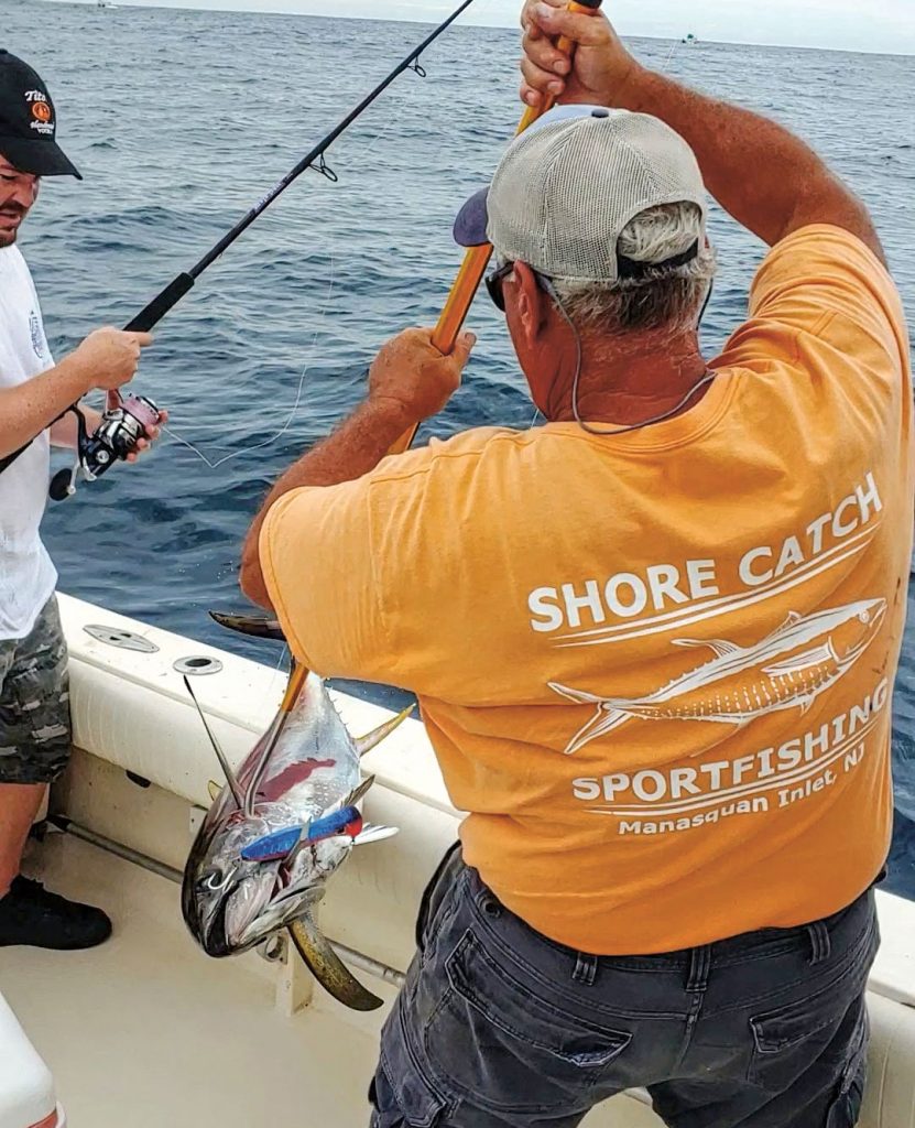 pulling gaffed tuna on deck