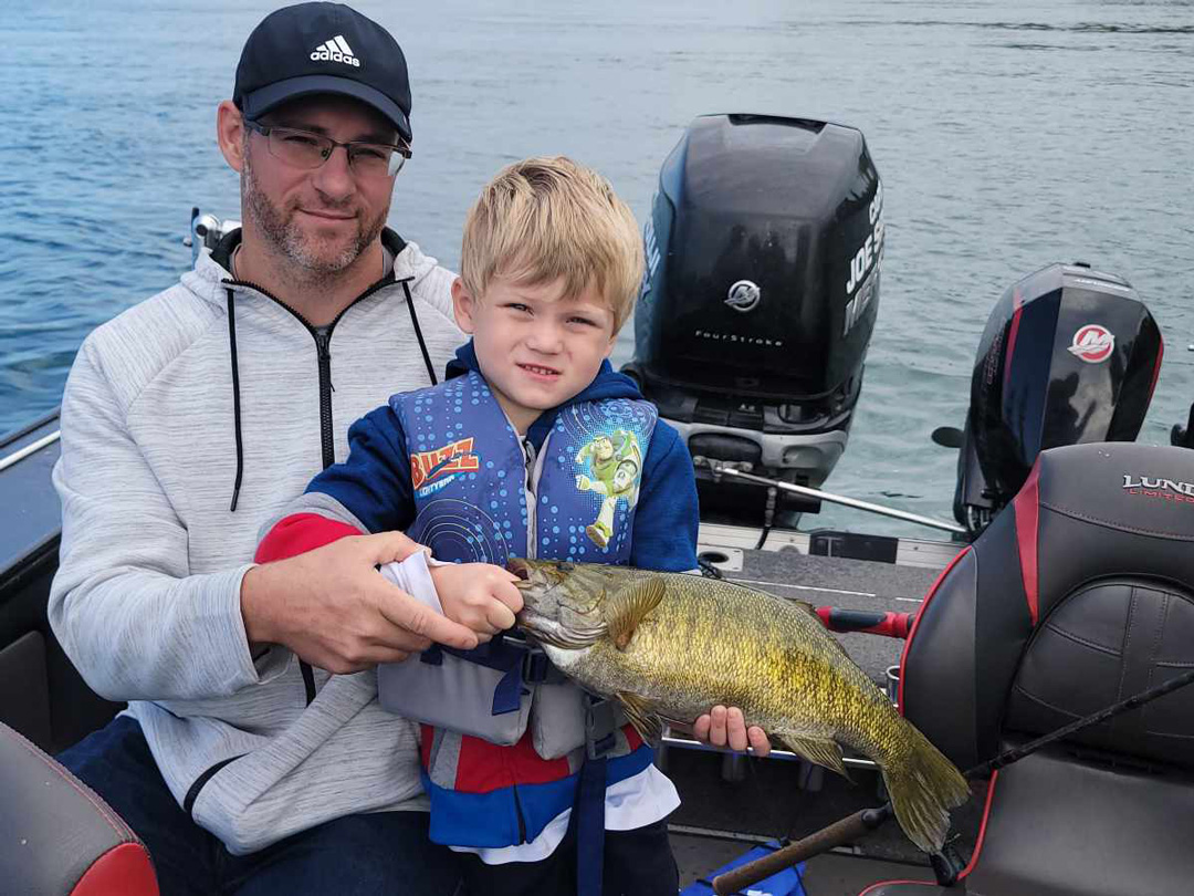 Enzo Keen and dad Devin with smallmouth bass