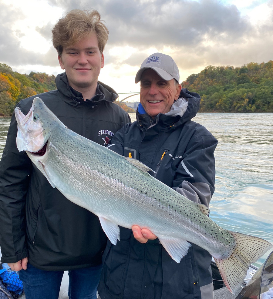Logan Ellingson and Capt. Joe Marra with steelhead