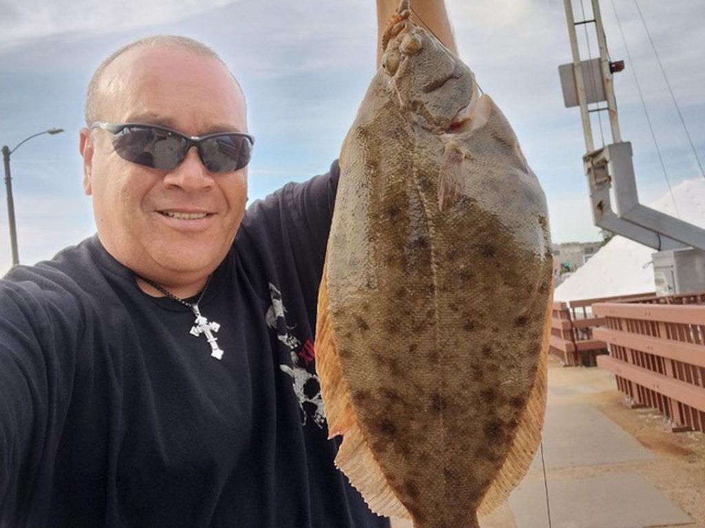 Jesus Agostini with flounder