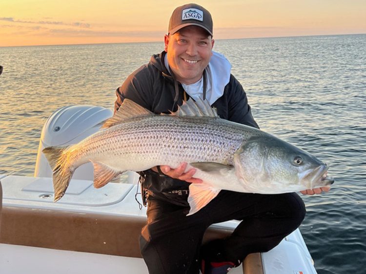 Captain Lou Tirado with striped bass