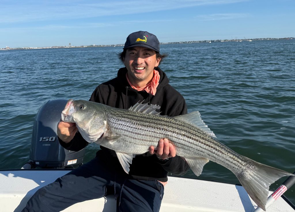 Peter Neal with Boston Harbor striped bass