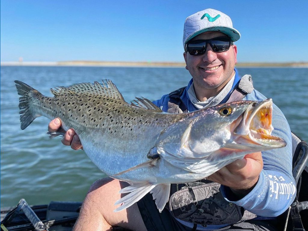 Big specks will chew even under bluebird skies if there is an ample supply of baitfish and a hard-running tide.